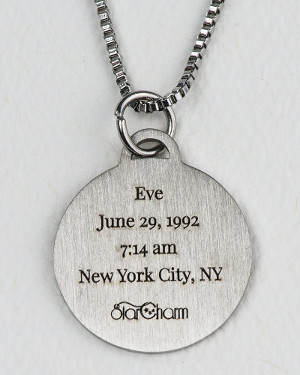 Back side of silver-colored StarCharm pendant showing name, birth date and time, and birthplace of the person whose natal chart is engraved on the front