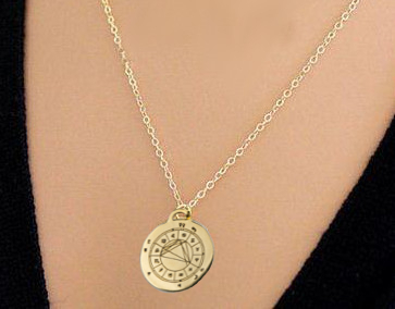 woman wearing personalized StarCharm pendant engraved with her astrological natal chart